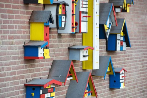 Many colorful birdhouses at the wall