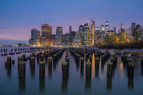 Illuminated Skyline of Lower Manhattan and River with Piers at Twilight. New York City