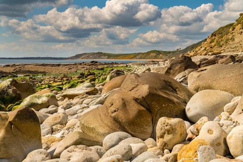 Stones and clouds at Osmington Bay, Osmington Mills, near Weymouth, Jurassic Coast, Dorset, UK