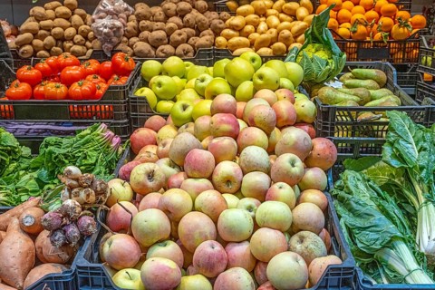 Apples and vegetables for sale at a market