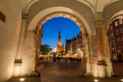 View of the old town of Gdansk with the Main Town Hall through the arch of Green Gate, Poland,