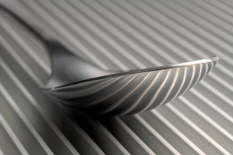 Abstract artistic picture of a spoon on a parallel grid structure