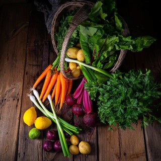 Basket with various vegetables: beetroot and carrots