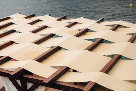 Unusual roof closure. The roof of the restaurant on the street by the sea. The fabric roof. SUMMER