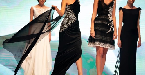 Female models walk the runway in beautiful black dresses during a Fashion Show. Fashion catwalk