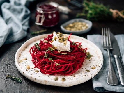 Beetroot pesto or hummus. Homemade beet pesto sauce in glass jar and fresh thyme on dark black