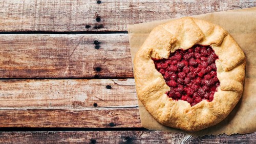 Perfect raspberry galette. Delicious rustic homemade tart with frozen or fresh raspberries on old
