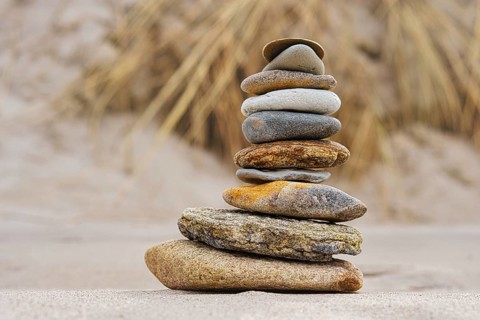Stone pyramid on the beach at Zingst. Stones stacked on top of each other by the sea