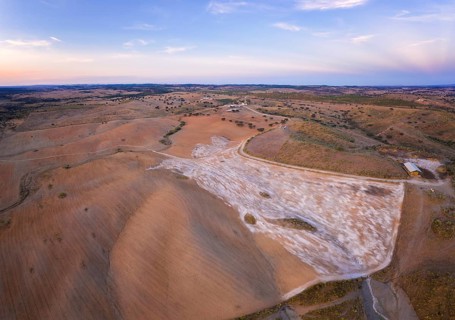 Drone aerial panorama of a desert like hill landscape with marble stones dust at sunset in Terena,