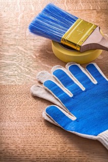 Safety gloves duct tape with paintbrush on wood board maintenance concept