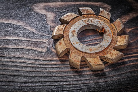 Rusted milling cutter on vintage wooden board construction concept