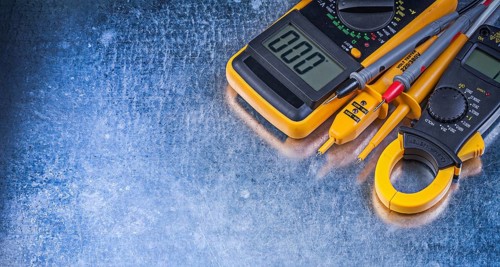 Digital ammeter electric tester multimeter on metallic background