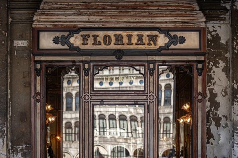 Historic façade of the famous Caffè Florian with reflective windows, Piazza San Marco, symbolic