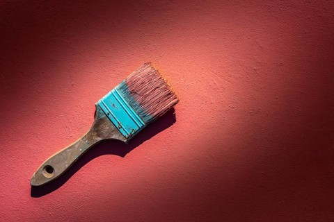 Coral color grunge brush with paint in monochromatic coral background wall