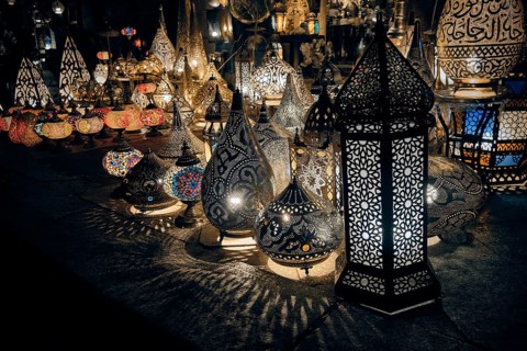 Glowing arabic lamps for sale in front of egyptian souvenir shop. Traditional middle eastern