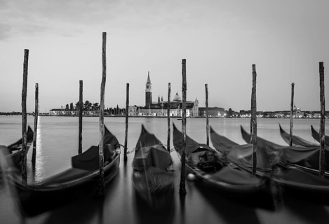 Moving Gondolas on Venice waterfront, San Giorgio Maggiore on the background