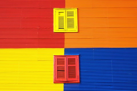 Colourful wall with two windows in La Boca, Buenos Aires