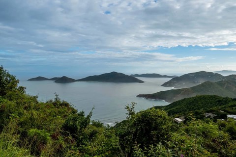 Tortola, in the British Virgin Islands, captivates with lush hills, white sand beaches, and vibrant