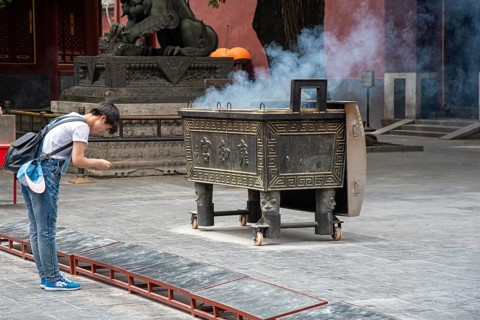 Beijing, China, June 8 2018 : Religious man praying at the Lama temple which is the biggest Tibetan