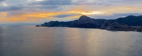 Sunset on the Black Sea coast of Crimea. View from the top of Cape Alchak to the west, towards