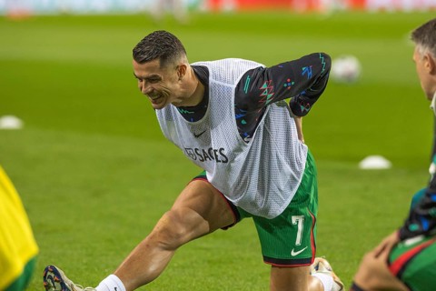 Football match, Cristiano RONALDO CR7 Portugal kneeling during pre-match warm-up with right leg and