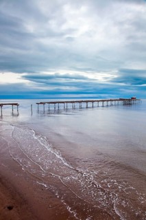 Ruined ocean pier in Punta Arenas. Strait of Magellan. South America. The famous Tierra del Fuego