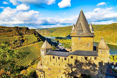 Round towers with conical peaked roofs. Sunset. Rhine Castles: Journey into the German Middle Ages.