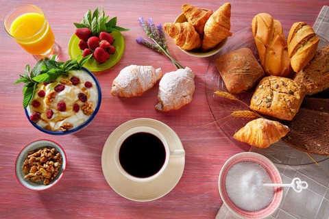 Coffe breakfast with orange juice croissant bread and strawberries
