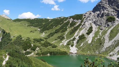 On the Saalfelder Höhenweg in the Tannheimer Tal with a view of the pool in front of the