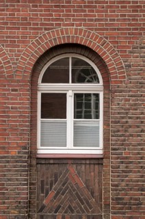 Large mullioned window on a 100-year-old building