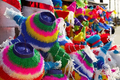 Mexican party pinatas decorated with fringed tissue colorful paper