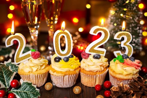 Food tray with cupcakes new year candles and wineglasses