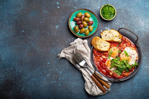 Middle Eastern and Maghrebi healthy dish Shakshouka made of eggs and tomato sauce served in pan