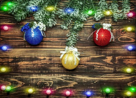 Balls and garland at fir branch on wooden background