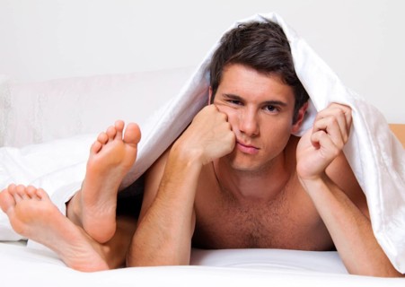 A young couple in bed having problems and crisis. Divorce and separation, A young couple in bed