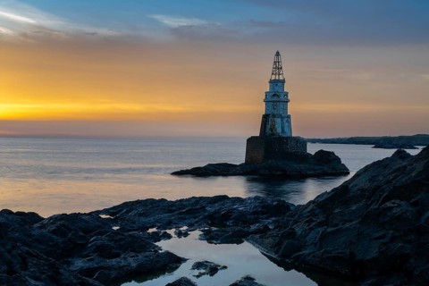 The Athopol Lighthouse on the Black Sea coast of Bulgaria with tidal pools in the foreground at