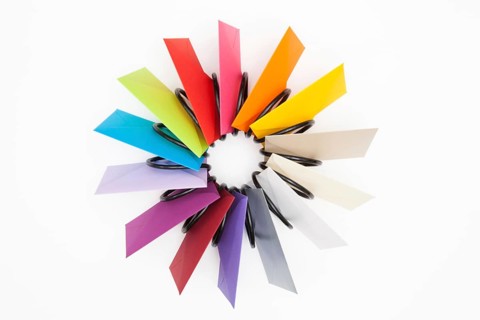 Propeller of colored envelopes on the white table