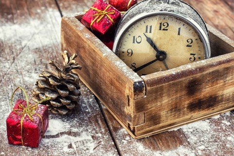 Outdated watch in wooden box on the background of Christmas decorations and pine cones