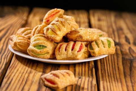 Cookies from puff pastry with coloured jam