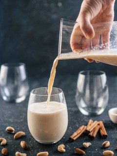 Thandai or Sardai cold drink made during Holi festival. Cold milk drink poured in glass, with