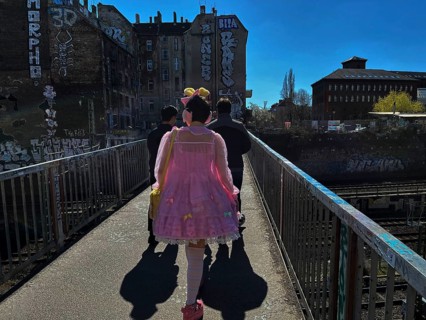 Germany, Berlin, 04.04.2025, girl / woman in pink dress, with bee antennae, Schönfliesser makeshift