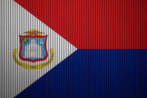 Sint Maarten Flag painted on the cracked grunge concrete wall