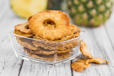 Some homemade Dried Pineapple Rings as detailed close-up shot, selective focus