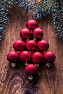 Red christmas baubles in the form of fir tree and branches firtree vintage wood board