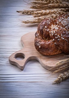 Chopping board wheat rye ears bread stick on wooden background food and drink concept