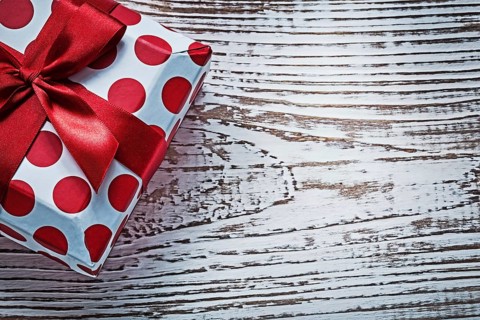 Gift box on vintage wooden board holidays concept