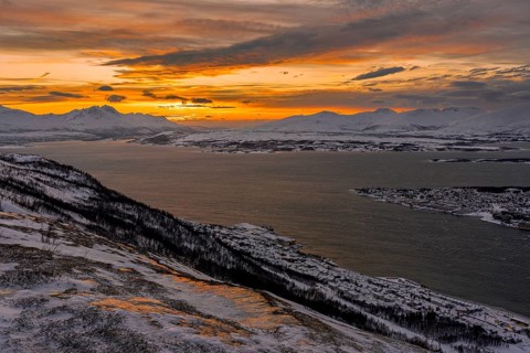 Winter view from Mount Storsteinen to the southern tip of Tromso at sunset, Troms, Norway, Europe