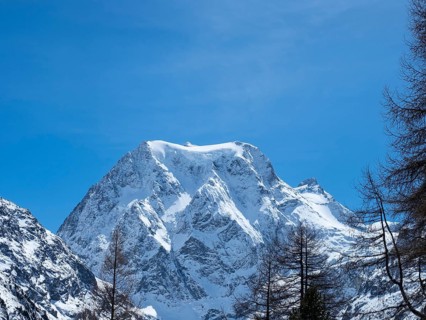 Beautiful view from Arolla, Switzerland, in winter: A high alpine peak with steep slopes covered