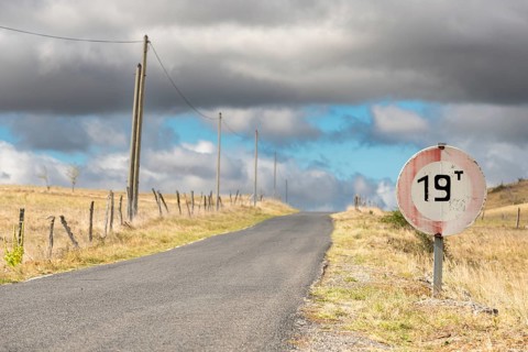 Desolate road in the countryside on a sunny summer day. Cevennes, France, Europe