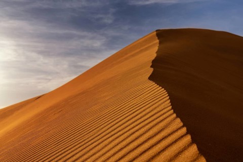 A view of the sand dunes at Erg Chebbi in Morocco in warm evening light